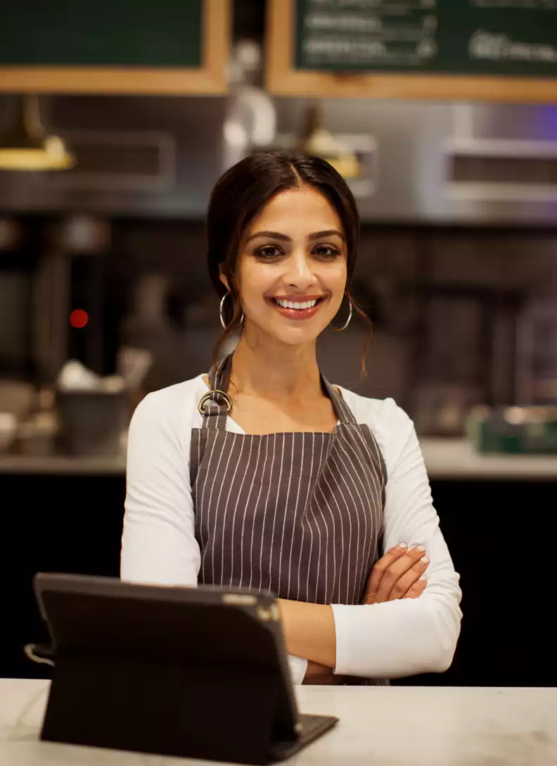 A woman behind the counter at a restaurant.