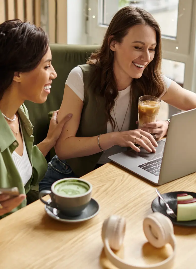 Two women enjoying music and coffee at a café